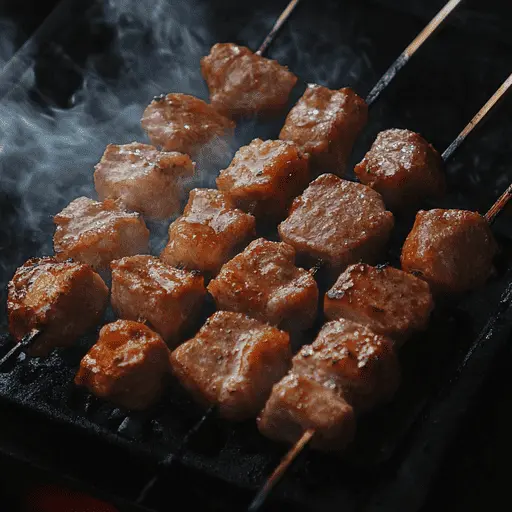 Grilling steak over open flames on an outdoor barbecue